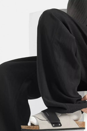 Black wide-leg lounge sweatpants with a relaxed fit and casual styling.