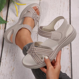 Khaki woven criss-cross platform sandals with adjustable strap.