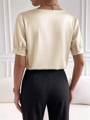 Pearl-trimmed satin bodysuit with short sleeves and a V-neckline.