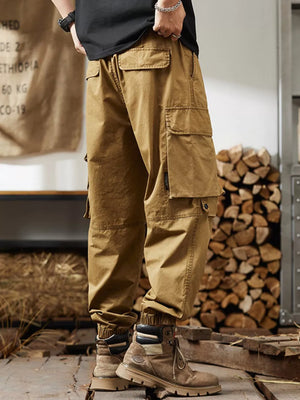 Khaki cargo pants with multiple pockets and elastic cuffs, worn by a man.