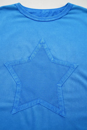Blue mineral wash cotton tee with a textured star patch and raw edge neckline.