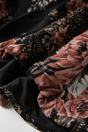 Black floral print blouse with blouson sleeves and metallic threads, showing fabric detail.