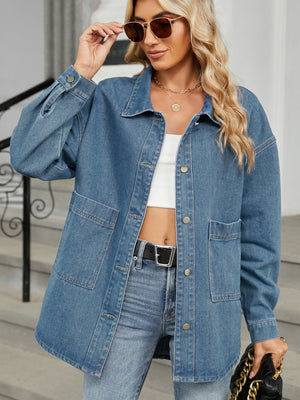 Oversized denim trucker jacket in medium blue with button front and chest pockets.