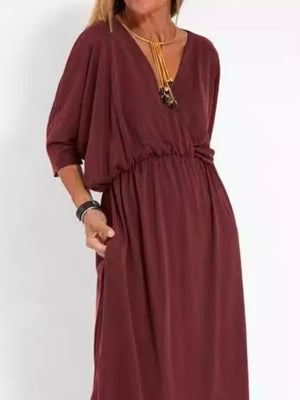 Wine red V-neck maxi dress with dolman sleeves, elastic waist, and side slits.