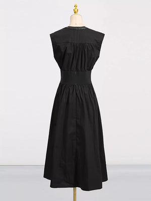 Black midi dress with elastic waistband, ruched bodice, and faux leather collar detail.