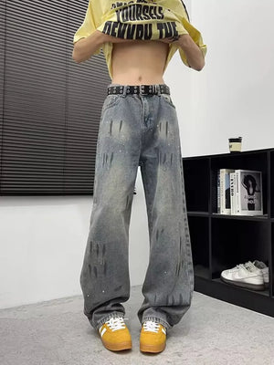Edgy wide-leg denim jeans for men in blue with distressed details and paint splatters.