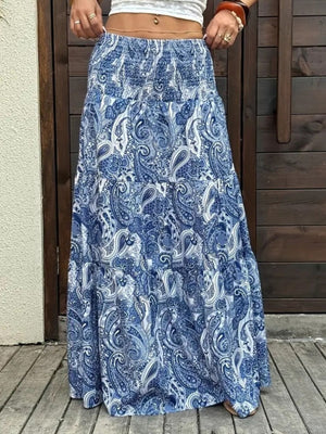 Bohemian maxi skirt in blue paisley print with tiered ruffles and smocked waist.