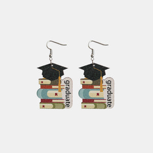 Graduation stacked book drop earrings with black caps and yellow tassels.