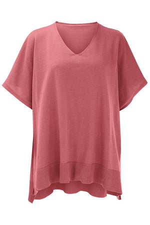 Relaxed V-neck knit poncho top in dusty pink with short sleeves and ribbed hem.