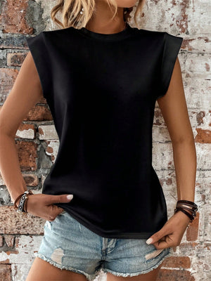 Black cap sleeve blouse with padded shoulders, styled with denim shorts.