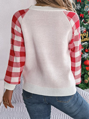 White sweater with red gingham sleeves and crew neck.
