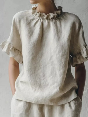 Apricot linen shirt with ruffled neckline and half sleeves.