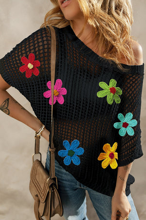 Black crochet mesh overlay top with colorful floral appliques and short sleeves.