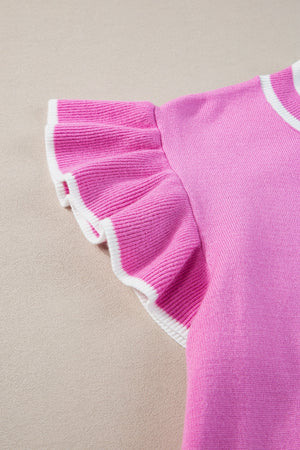 Fuchsia pink knit top with ruffled sleeves and contrast white trim.