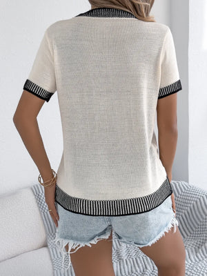 Cream knit tee with black contrast trim on collar, sleeves, and hem.
