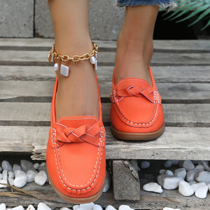 Orange-Red leather loafers with braided detail and white stitching.