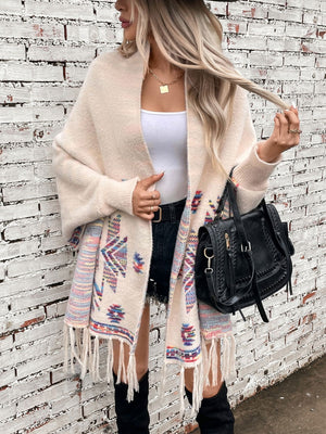 Cream Aztec fringe knit cardigan with colorful geometric pattern and fringe detail.