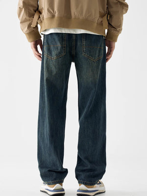 Loose fit blue cotton denim jeans with vintage wash and distressed details.