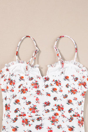 White floral bustier camisole with ruffle trim and adjustable straps.