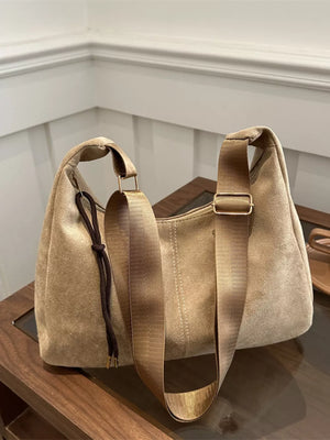 Khaki suede crossbody bag with adjustable strap and drawstring detail