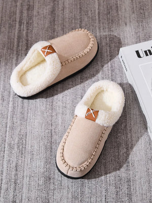 Caramel suede moccasin slides with shearling lining and decorative cross detail.