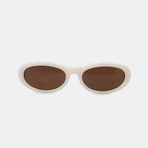Ivory cat eye sunglasses with brown lenses and thick frames.