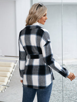 Black belted plaid overshirt with patch pockets and button-down front, styled casually.