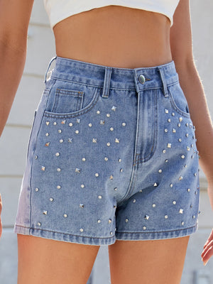 Medium wash denim high-waisted cutoff shorts with allover stud and rhinestone embellishments.