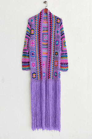 Lilac granny square crochet duster with multicolor details and long fringe.