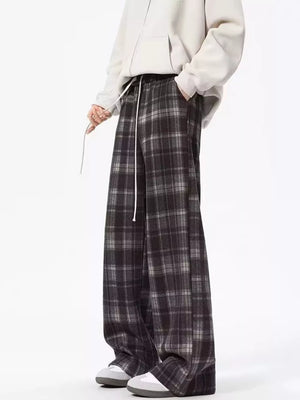 Plaid drawstring sweatpants in black with a relaxed fit and white drawstring.