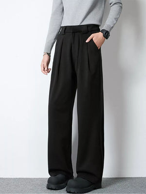 Men's black wide-leg pleated trousers with a relaxed fit and side pockets.