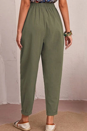 Relaxed linen tapered trousers in matcha green with elastic waist and cuffed hem.