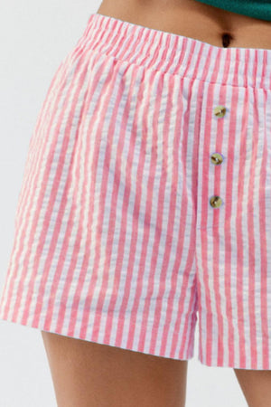 Pink and white seersucker boxer shorts with button fly and elastic waistband.