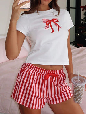 White t-shirt with red bow graphic and red and pink striped lounge shorts with red bow detail.