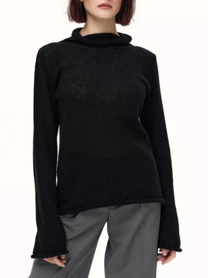 Black sheer mock neck knit sweater with draped neckline and raw hem detail.