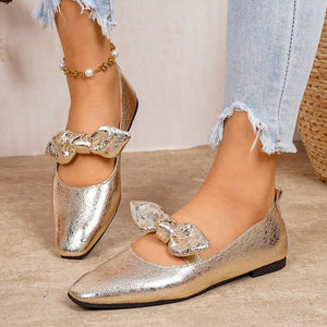 Gold square toe slip-on flats with bow detail and pearl anklet