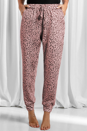 Dusty pink leopard print joggers with drawstring waist and cuffed ankles.