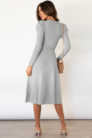 Light gray cable knit midi dress with self-tie belt and long sleeves.