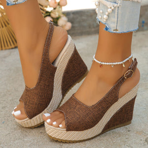 Brown woven espadrille wedge sandals with peep toe and ankle strap.