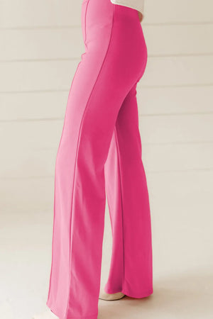 Pink seamed flare leg trousers with a high waist and wide leg