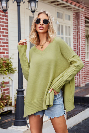 Lime acrylic sweater with v-neck, long sleeves, and asymmetric hemline.