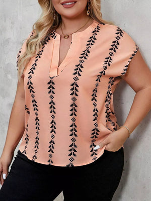 Plus-size peach v-neck blouse with black geometric stripes and short sleeves