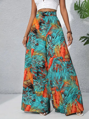 Palazzo trousers with tropical leaf print in teal and orange, made of 100% polyester.