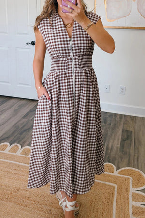 Gingham zip-front midi dress in taupe with smocked waist and pockets.