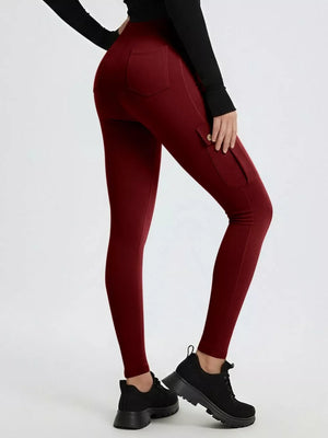 Burgundy maternity active pants with cargo pockets and a high waist.