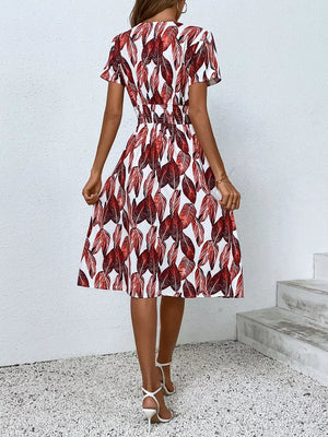 Red leaf pattern midi dress with smocked waist and short sleeves.