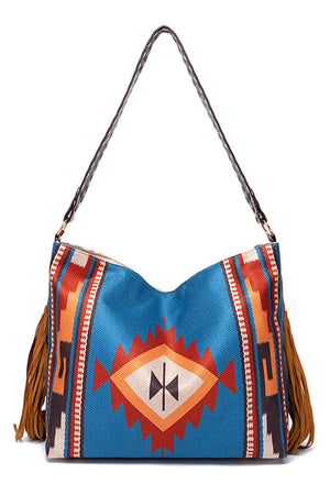 Southwestern fringe hobo bag in multicolor canvas with braided strap and suede fringe details.
