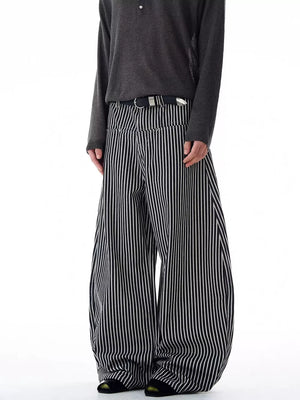 Men's black and white striped wide-leg sweatpants with a black belt.
