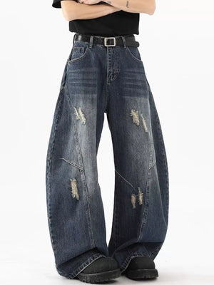 Distressed wide-leg jeans in Vintage Blue denim with a belt.