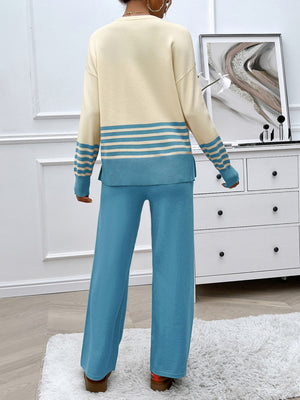 Color-blocked knit lounge set with cream sweater and blue striped sleeves, paired with blue wide-leg pants.